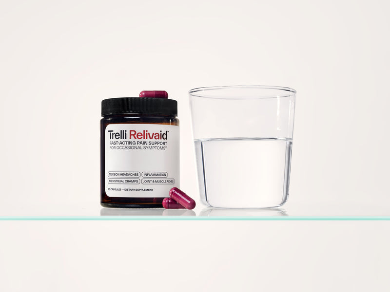 A jar of Trelli Relivaid beside a glass of water